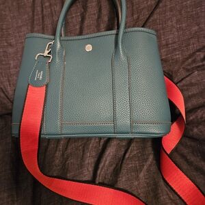 Elegant Green Handbag with Red Strap